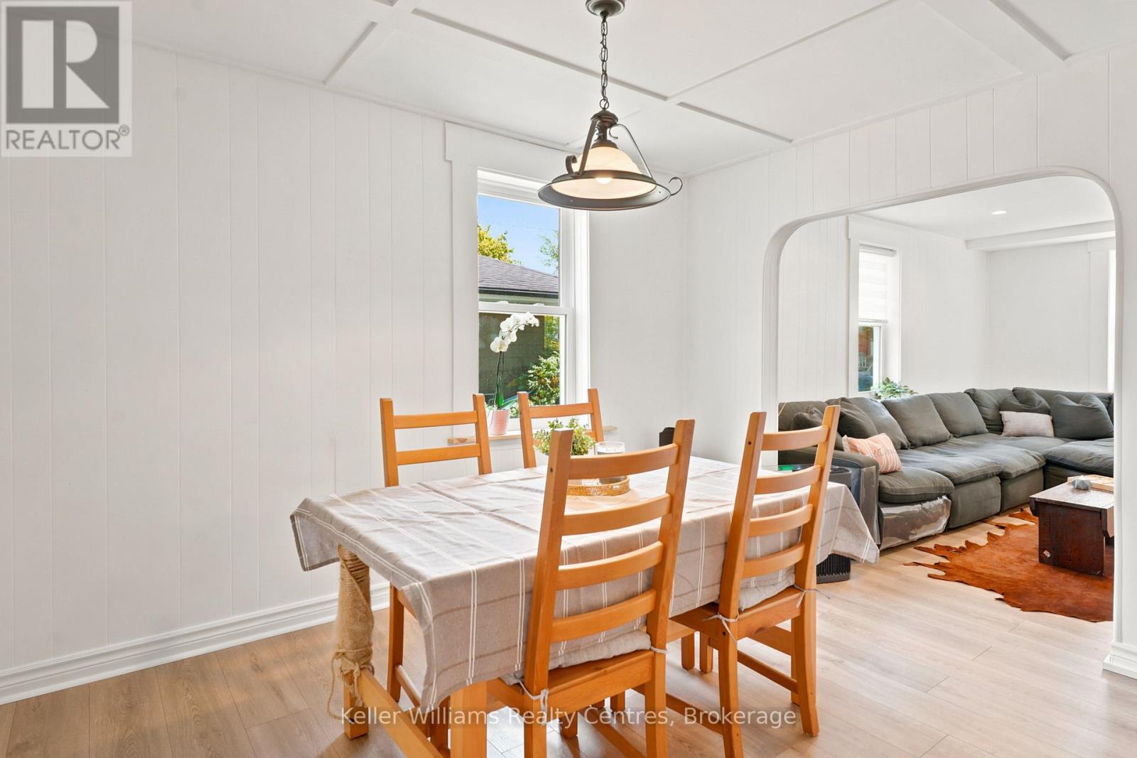 Dining room open to the living room with pendant light