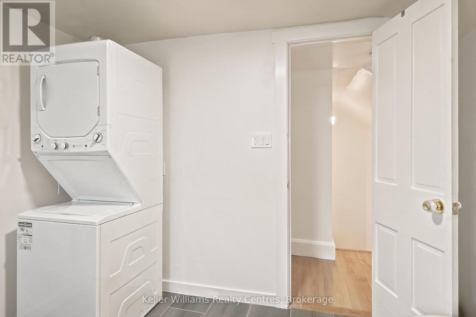 Stacked washer and dryer in upstairs laundry closet