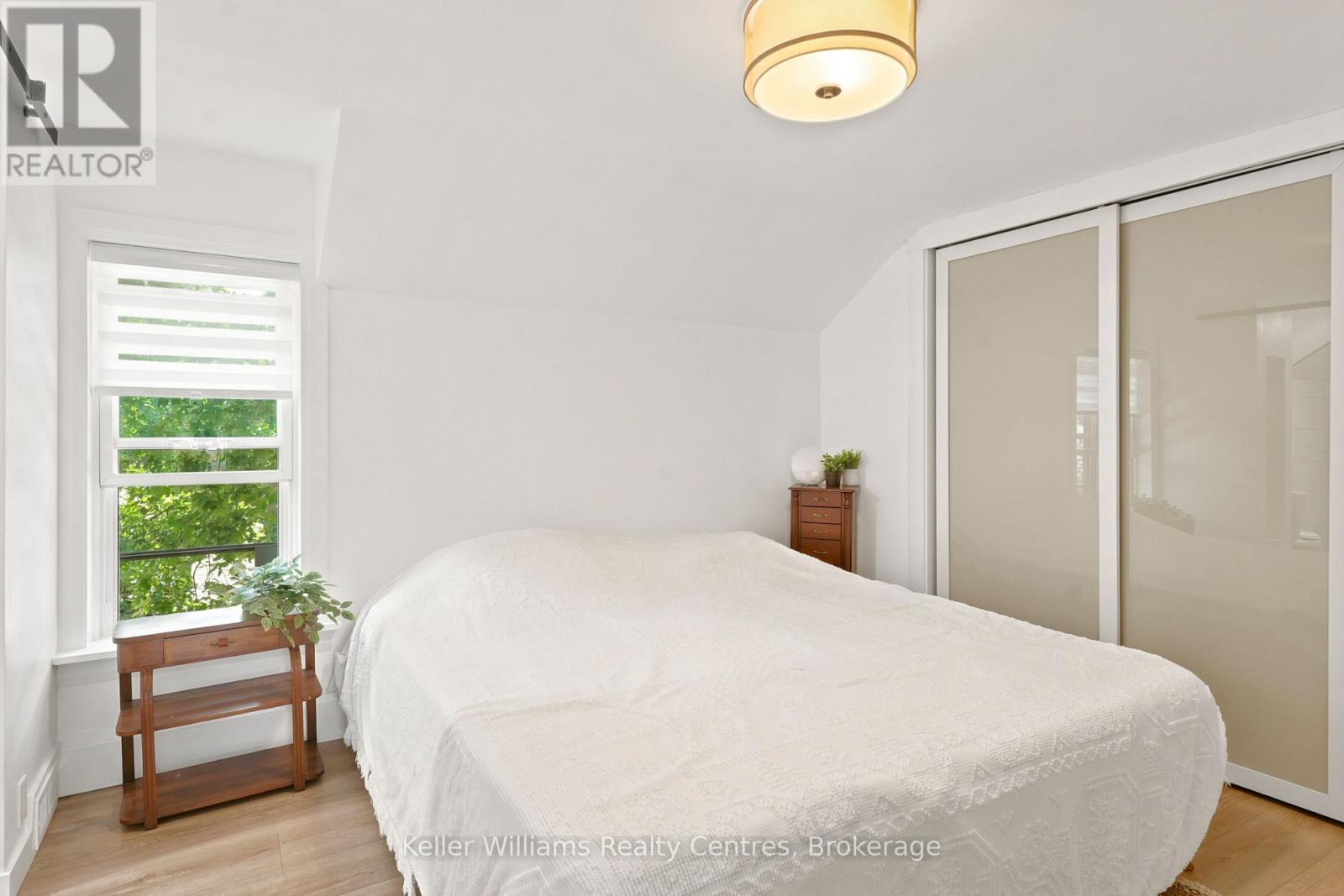 Primary bedroom with closet and bright window