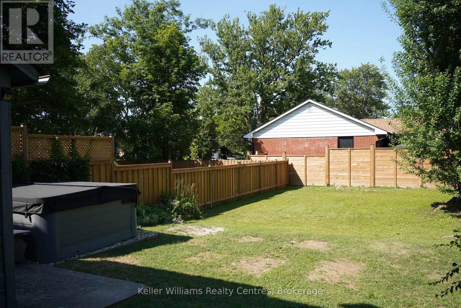 Hot tub on the back patio overlooking the fenced yard